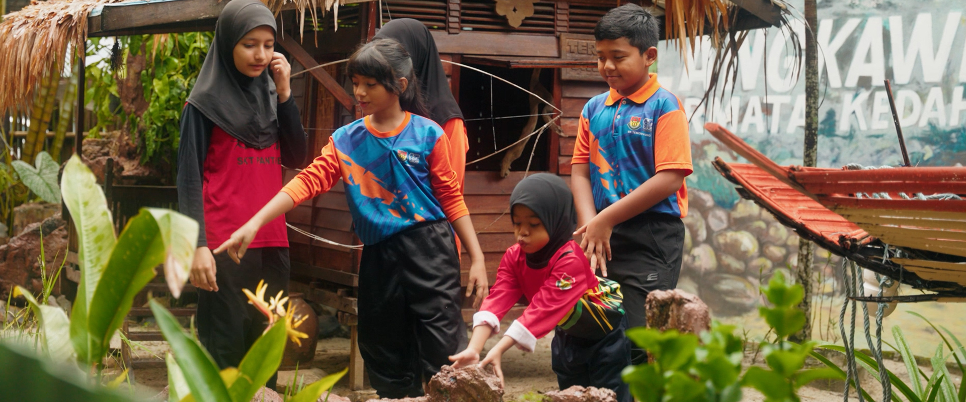 Students of the Eco-schools programme planting padi in the school garden